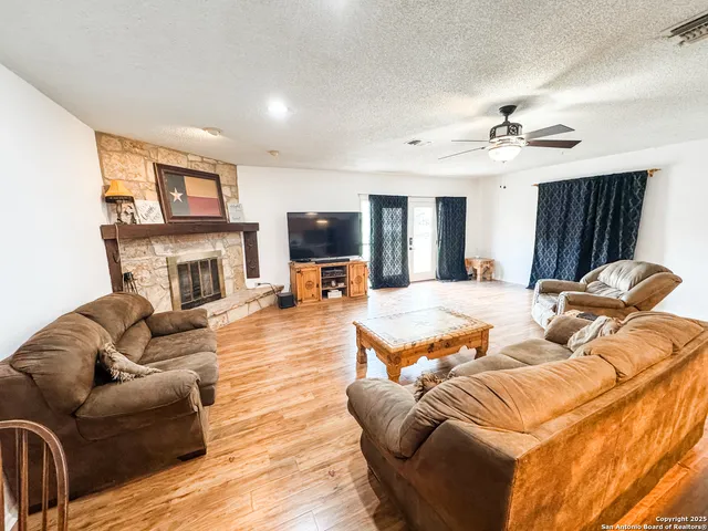 a living room with furniture fireplace and flat screen tv