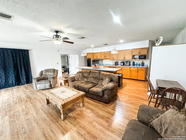 a living room with furniture and kitchen view