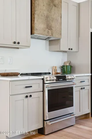 a white stove top oven sitting inside of a kitchen