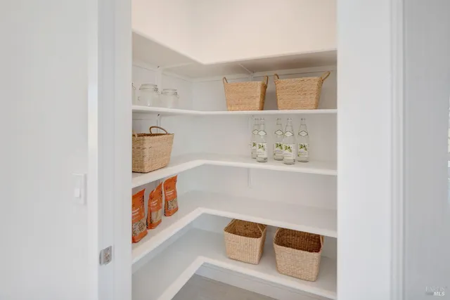 a hallway with white cabinets