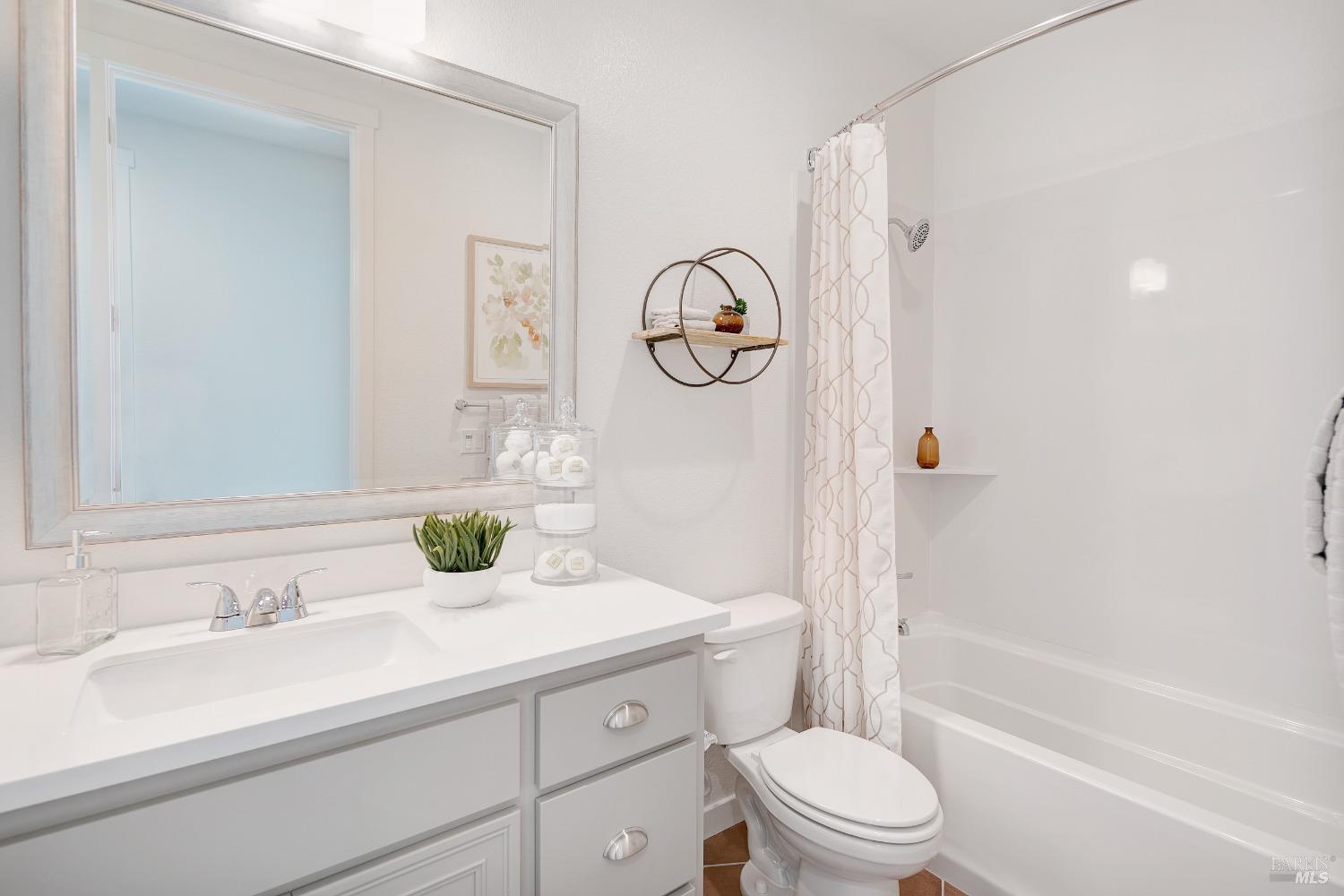 2438 Revival Lane Rio Vista, CA 94571 - Photo 16 of 40 a bathroom with a granite countertop sink a toilet and a bathtub
