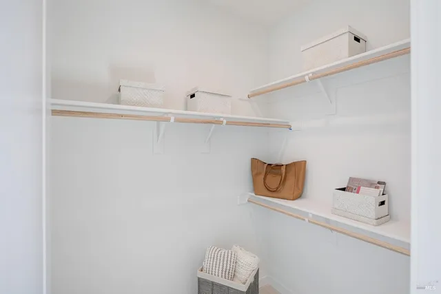 a white bath tub sitting next to a white sink and vanity