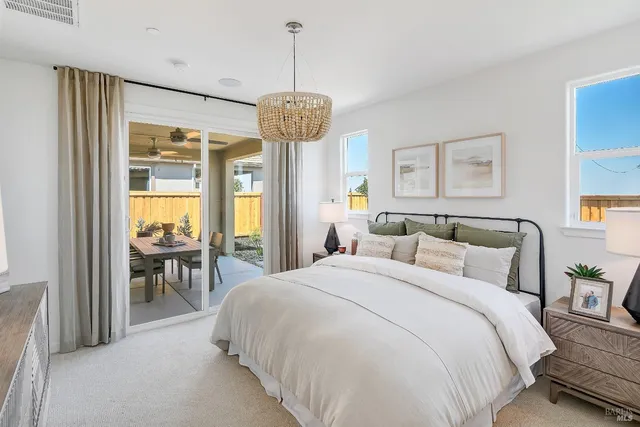 a spacious bedroom with a bed and a chandelier