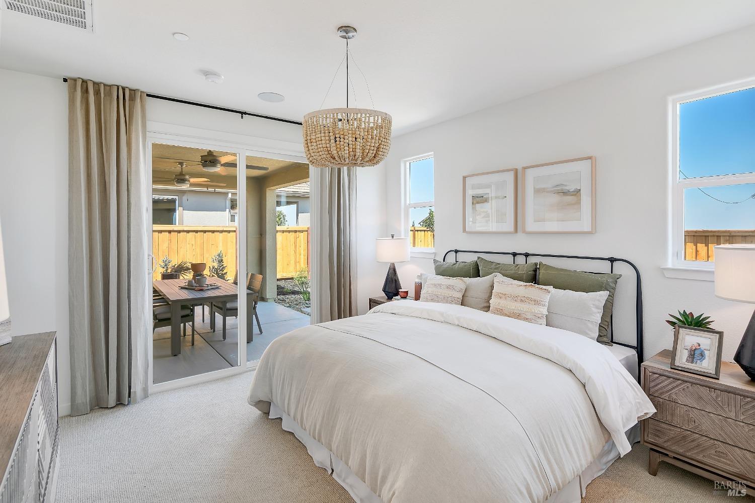 2438 Revival Lane Rio Vista, CA 94571 - Photo 24 of 40 a spacious bedroom with a bed and a chandelier