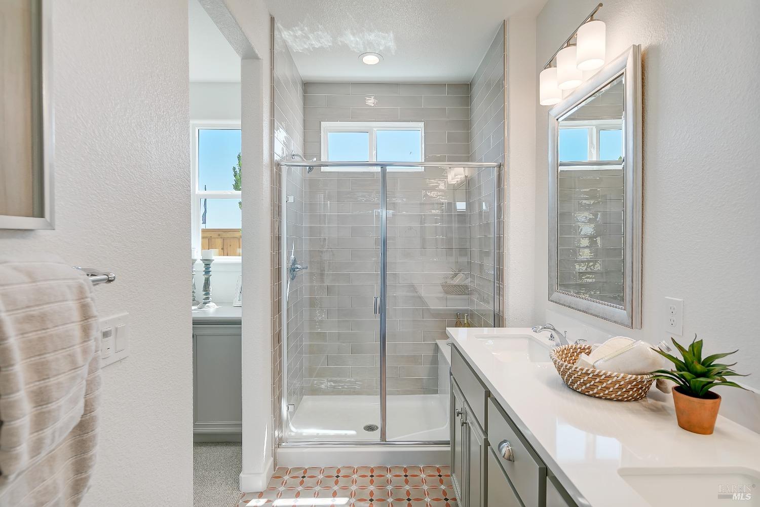 2438 Revival Lane Rio Vista, CA 94571 - Photo 27 of 40 a bathroom with a granite countertop sink a mirror and a shower