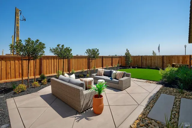a view of a patio with couches and a fire pit