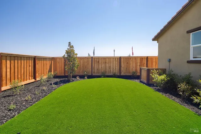 a view of a backyard with potted plants