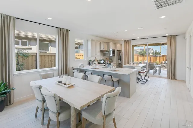 a dining room with furniture window and wooden floor