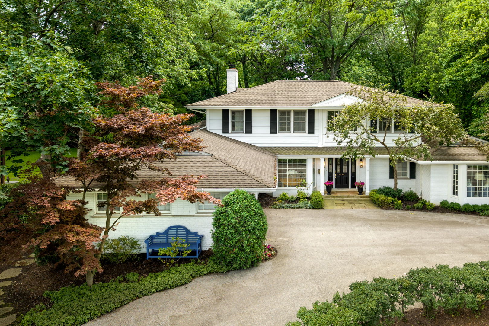 1118 Mt Pleasant Road Winnetka, IL 60093 - Photo 2 of 48 a front view of a house with a yard and green space