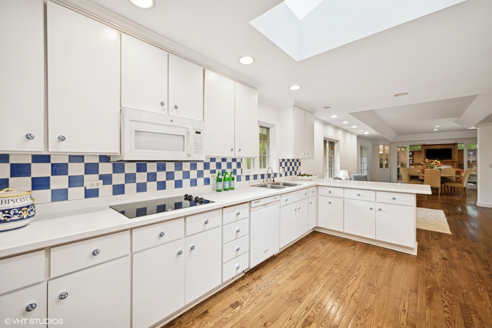 1118 Mt Pleasant Road Winnetka, IL 60093 - Photo 22 of 48 a large white kitchen with cabinets and wooden floor