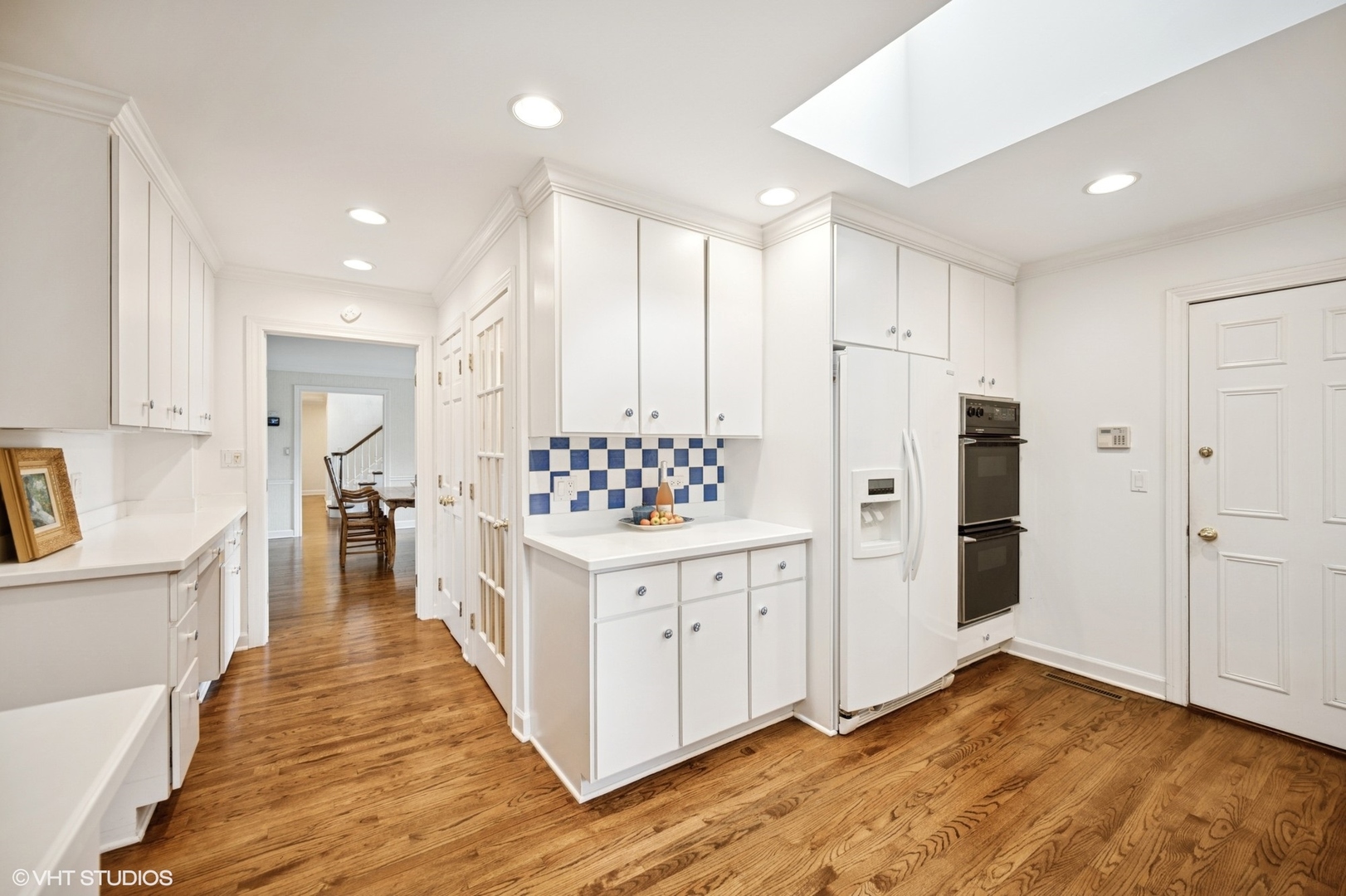 1118 Mt Pleasant Road Winnetka, IL 60093 - Photo 23 of 48 a kitchen with white cabinets and stainless steel appliances