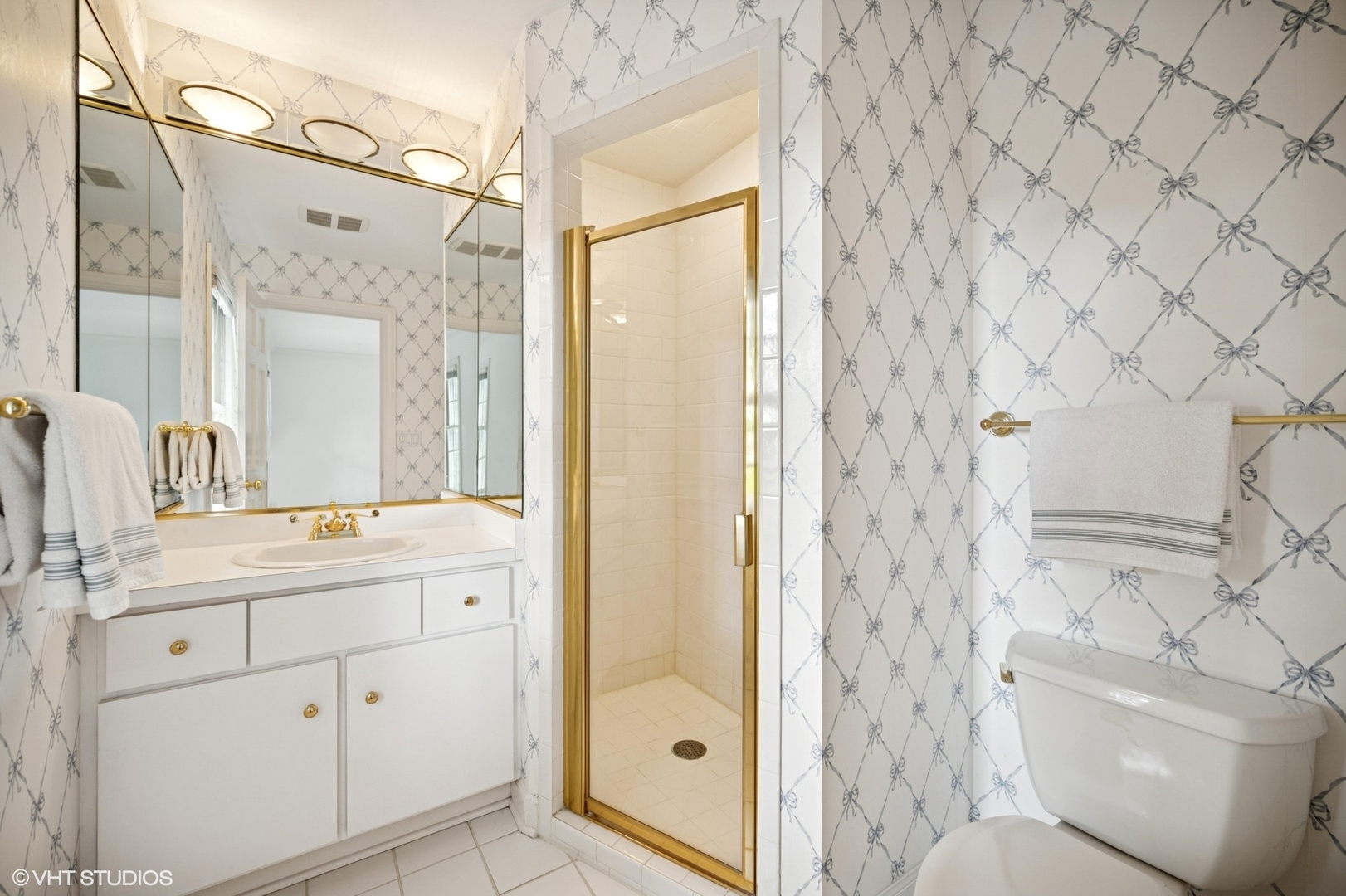 1118 Mt Pleasant Road Winnetka, IL 60093 - Photo 33 of 48 a bathroom with a granite countertop sink toilet a shower a mirror and a bathtub