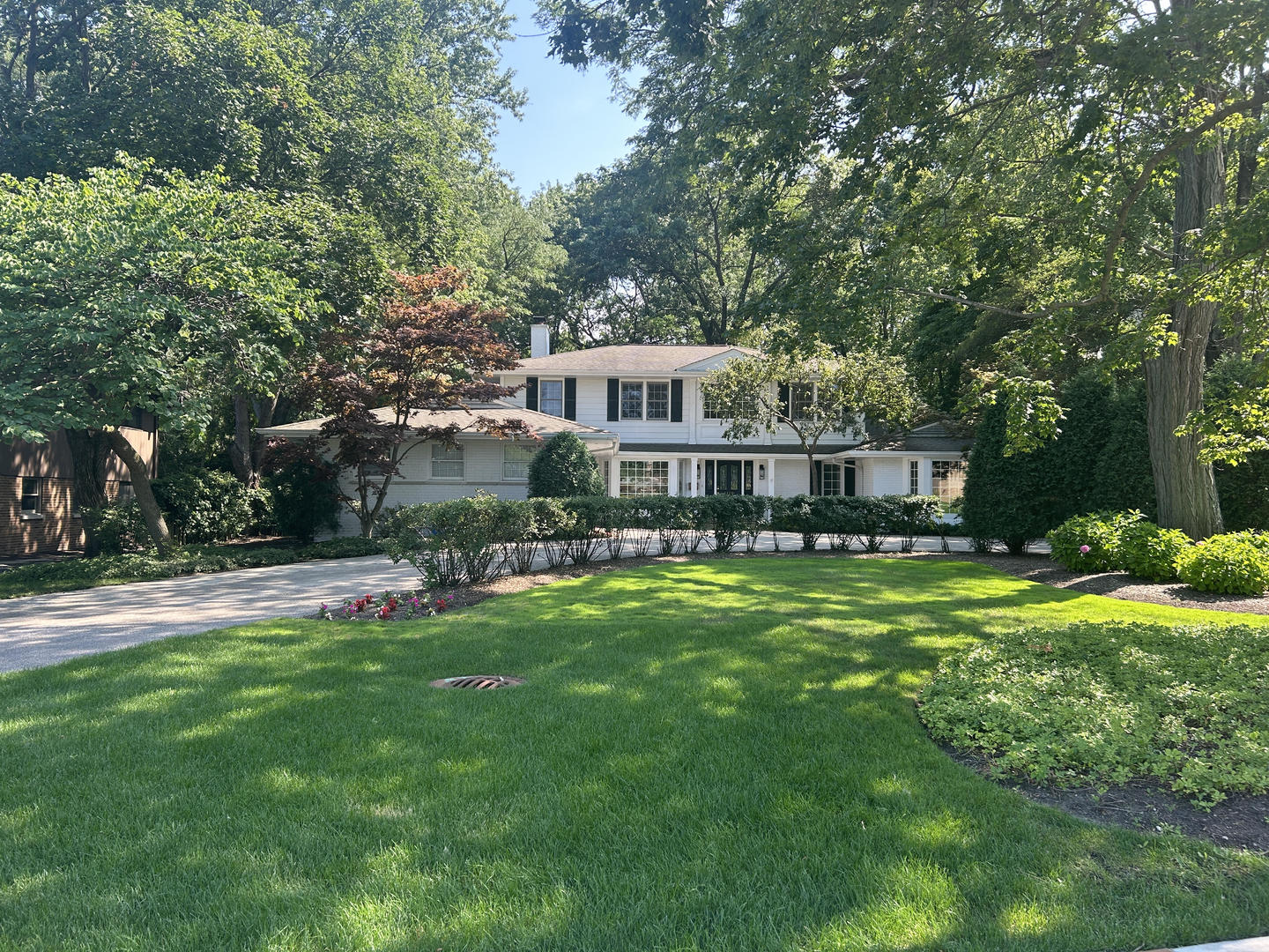 1118 Mt Pleasant Road Winnetka, IL 60093 - Photo 4 of 48 a front view of a house with a garden