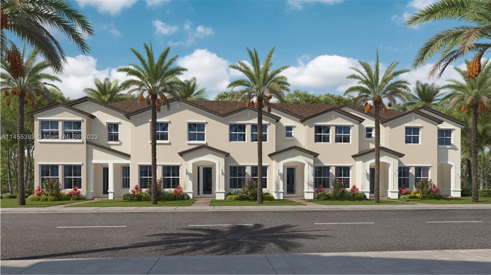 a view of a white house with a large space and palm trees