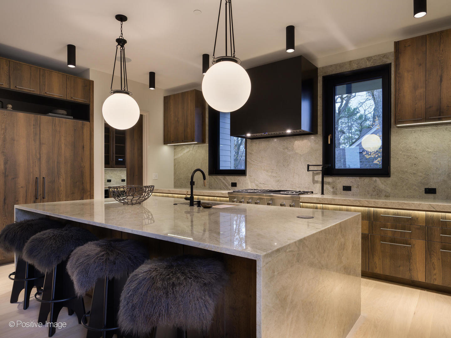 1106 Hohlfelder Road Glencoe, IL 60022 - Photo 25 of 61 a kitchen with kitchen island granite countertop a sink cabinets and wooden floor