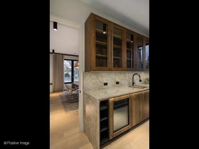 a kitchen with granite countertop a sink window and cabinets