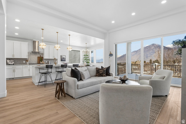 624 North Legend Circle, Unit 480 Mapleton, UT 84664 - Photo 13 of 34 Living room featuring a mountain view, a chandelier, and light wood-style floors