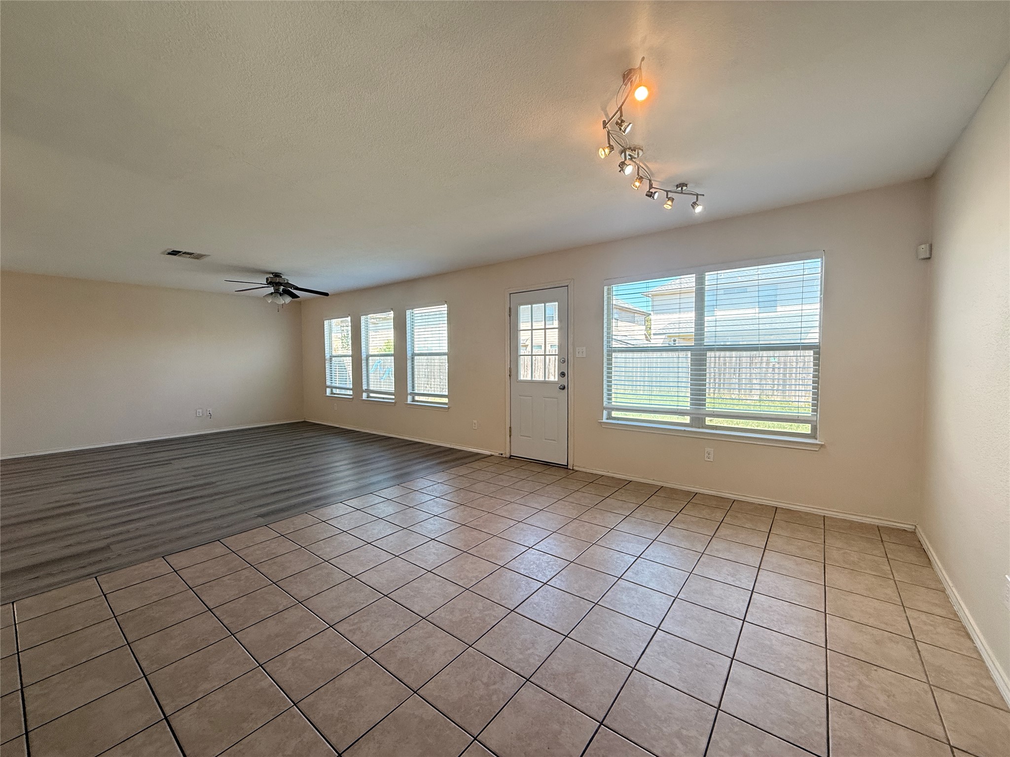 279 Housefinch Loop Leander, TX 78641 - Photo 14 of 30 Spare room with light tile patterned floors, a ceiling fan, and a textured ceiling