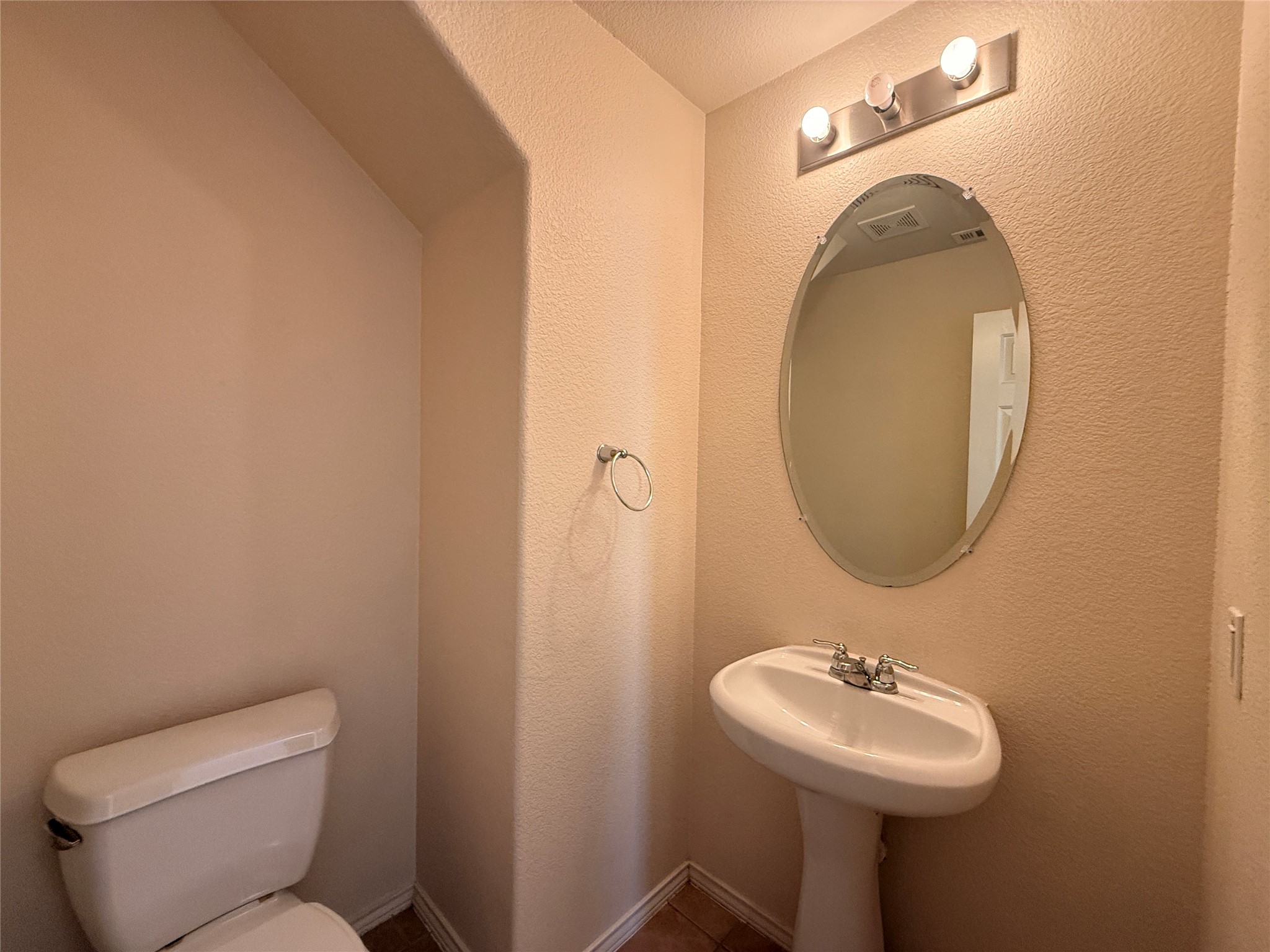 279 Housefinch Loop Leander, TX 78641 - Photo 15 of 30 Half bath featuring a textured wall and toilet