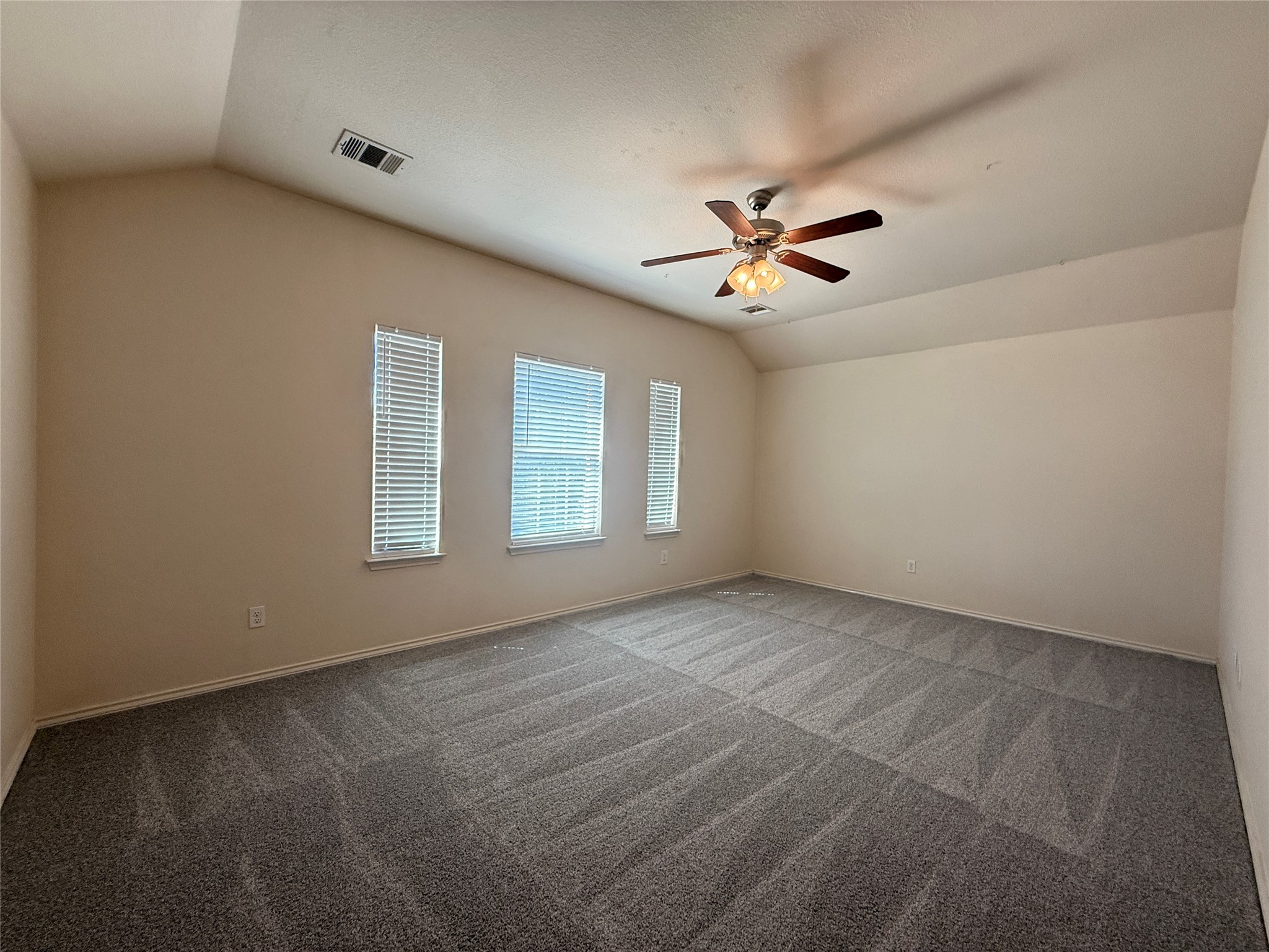 279 Housefinch Loop Leander, TX 78641 - Photo 23 of 30 Unfurnished room featuring dark carpet and ceiling fan