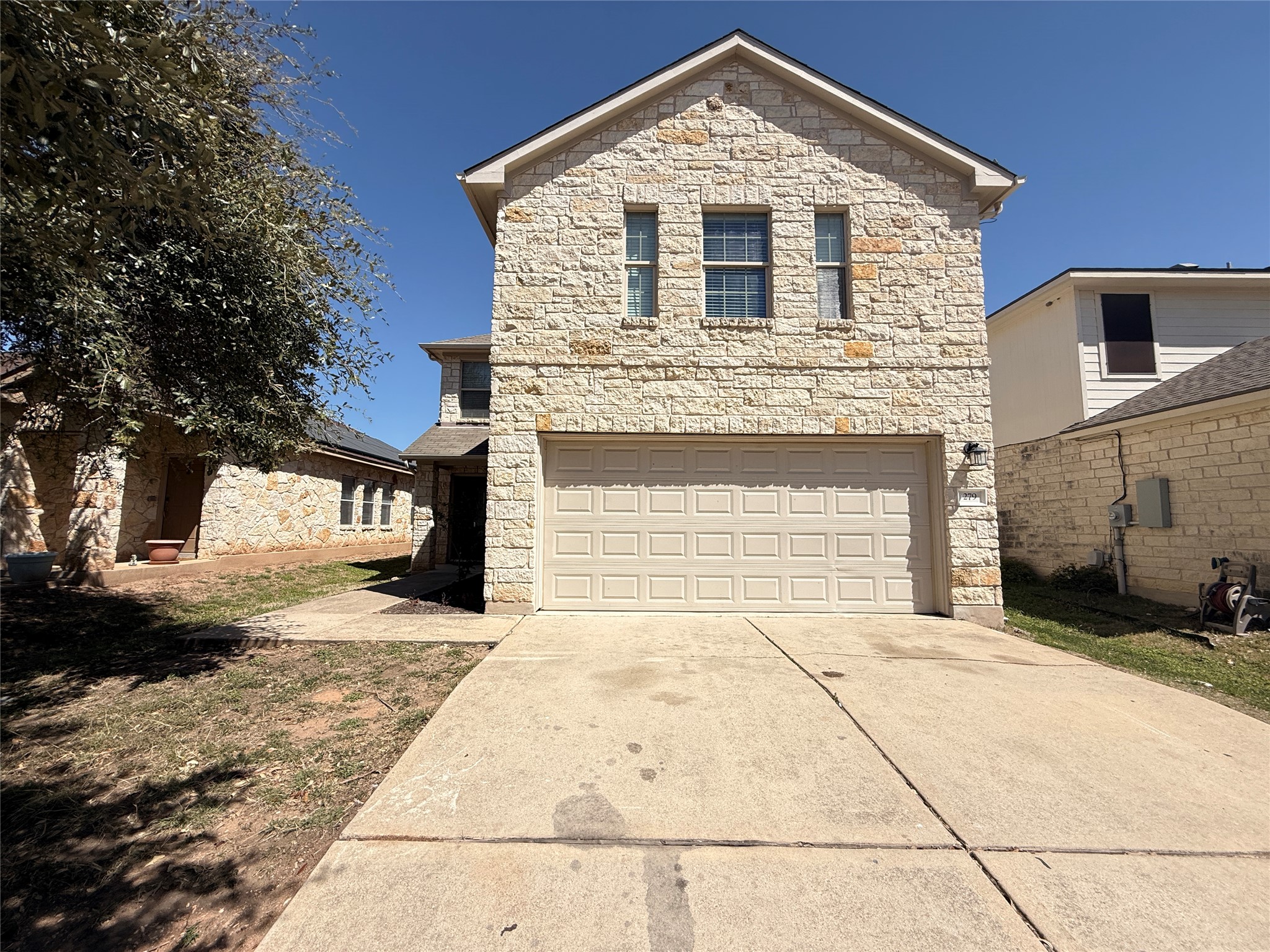 279 Housefinch Loop Leander, TX 78641 - Photo 28 of 30 Traditional-style home featuring stone siding, concrete driveway, and a garage
