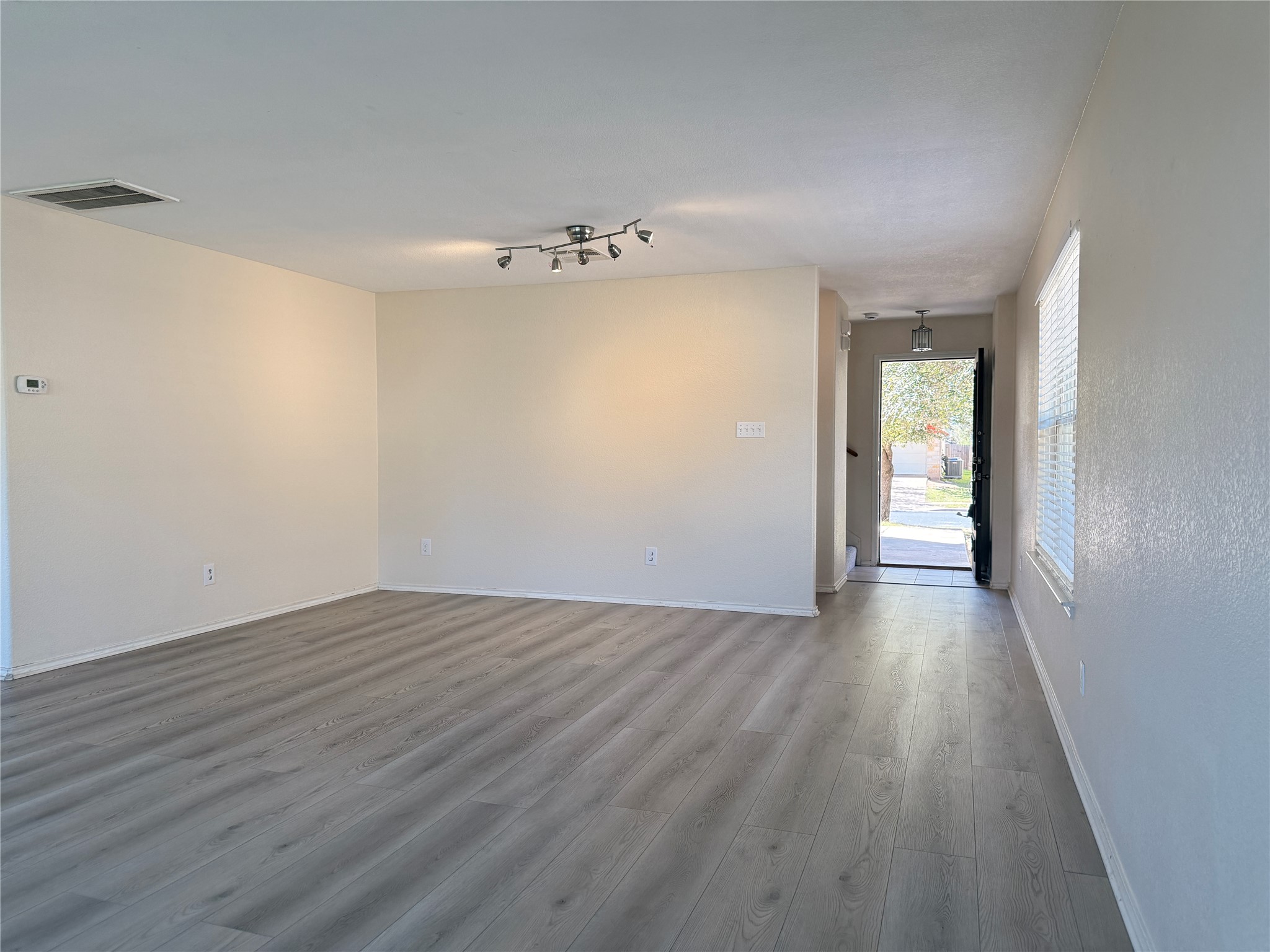 279 Housefinch Loop Leander, TX 78641 - Photo 4 of 30 Unfurnished room featuring dark wood finished floors and baseboards