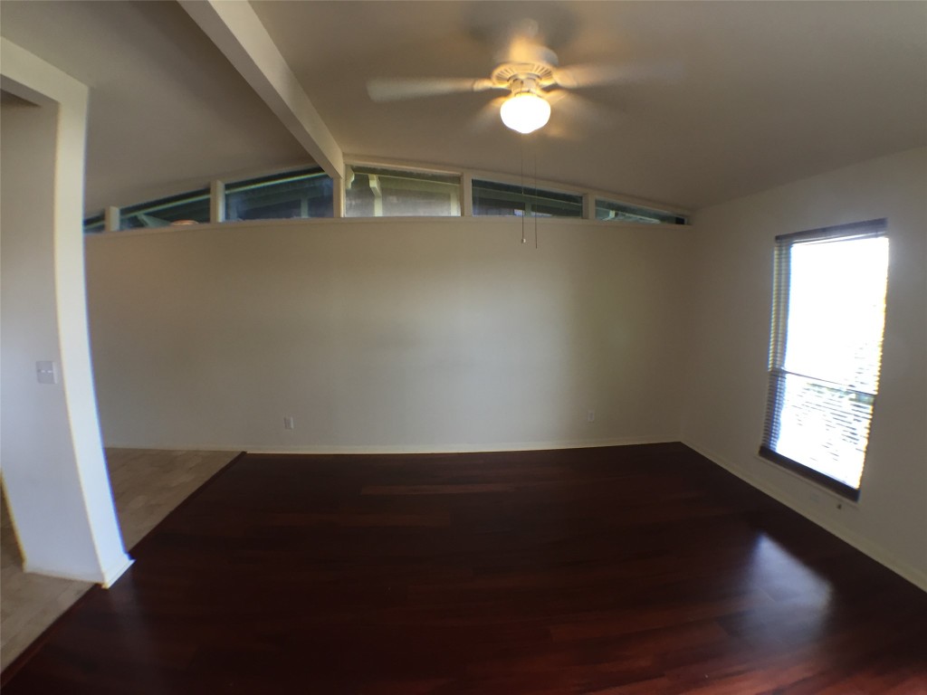 2703 Swisher Street, Unit 203A Austin, TX 78705 - Photo 5 of 11 a view of an empty room with a window and wooden floor