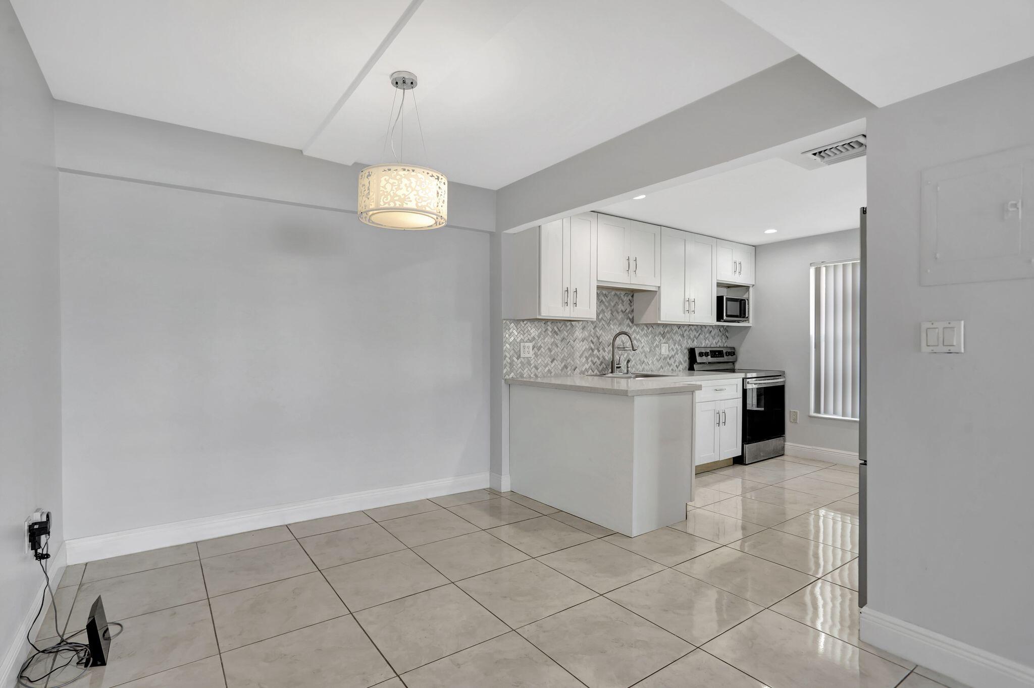 4156 Inverrary Drive, Unit 111 Lauderhill, FL 33319 - Photo 14 of 18 a view of kitchen with cabinets and refrigerator