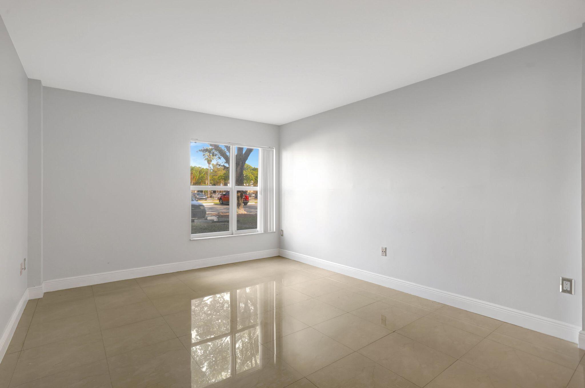 4156 Inverrary Drive, Unit 111 Lauderhill, FL 33319 - Photo 15 of 18 an empty room with windows