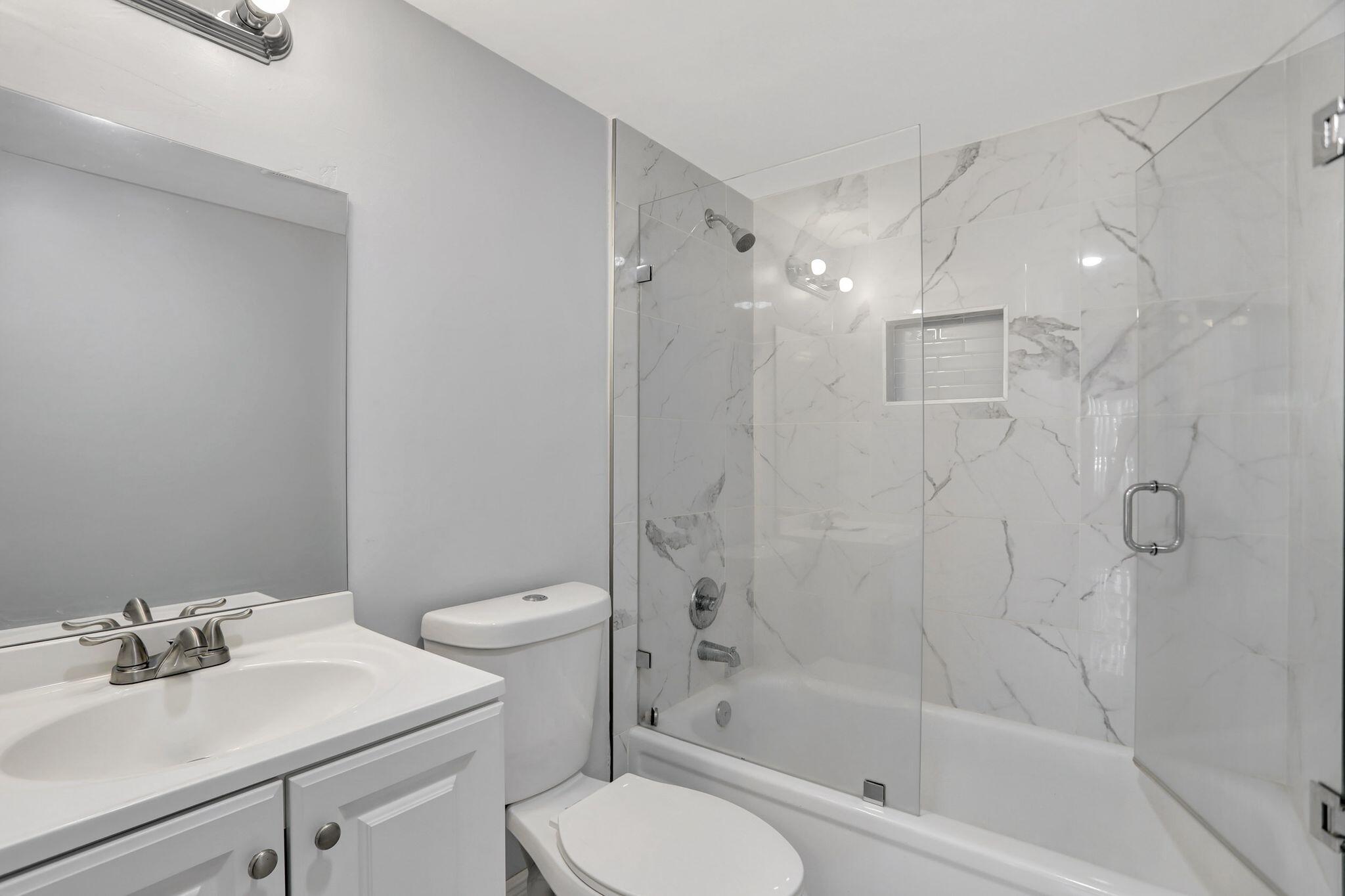 4156 Inverrary Drive, Unit 111 Lauderhill, FL 33319 - Photo 16 of 18 a bathroom with a sink toilet and shower