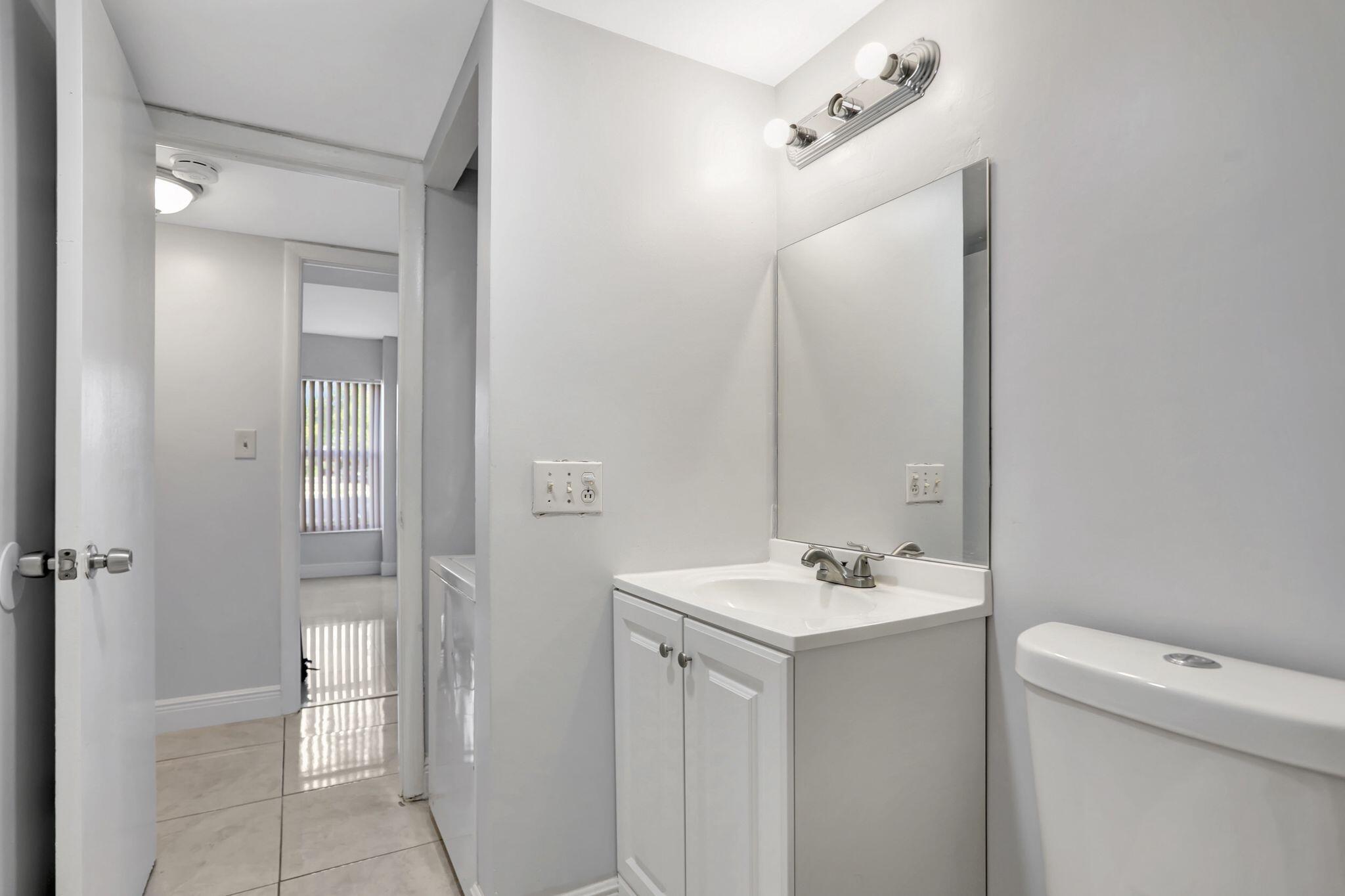 4156 Inverrary Drive, Unit 111 Lauderhill, FL 33319 - Photo 17 of 18 a bathroom with a sink a toilet and shower
