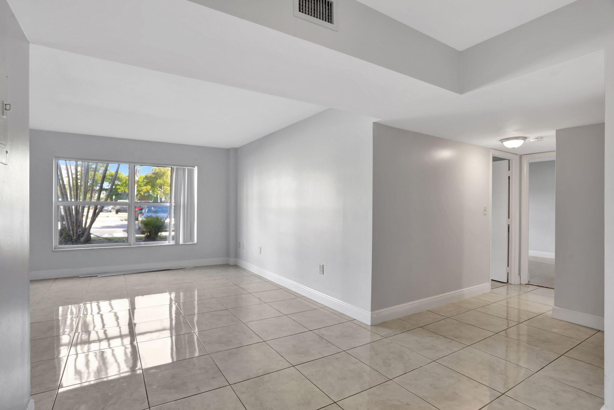 4156 Inverrary Drive, Unit 111 Lauderhill, FL 33319 - Photo 2 of 18 an empty room with windows and closet
