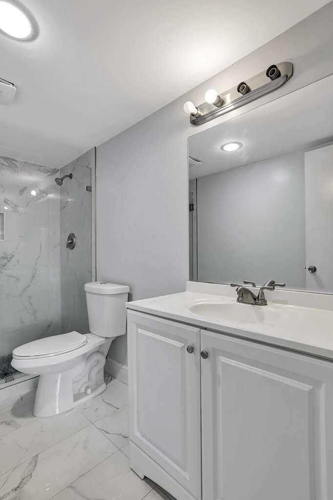 4156 Inverrary Drive, Unit 111 Lauderhill, FL 33319 - Photo 6 of 18 a bathroom with a sink toilet and shower