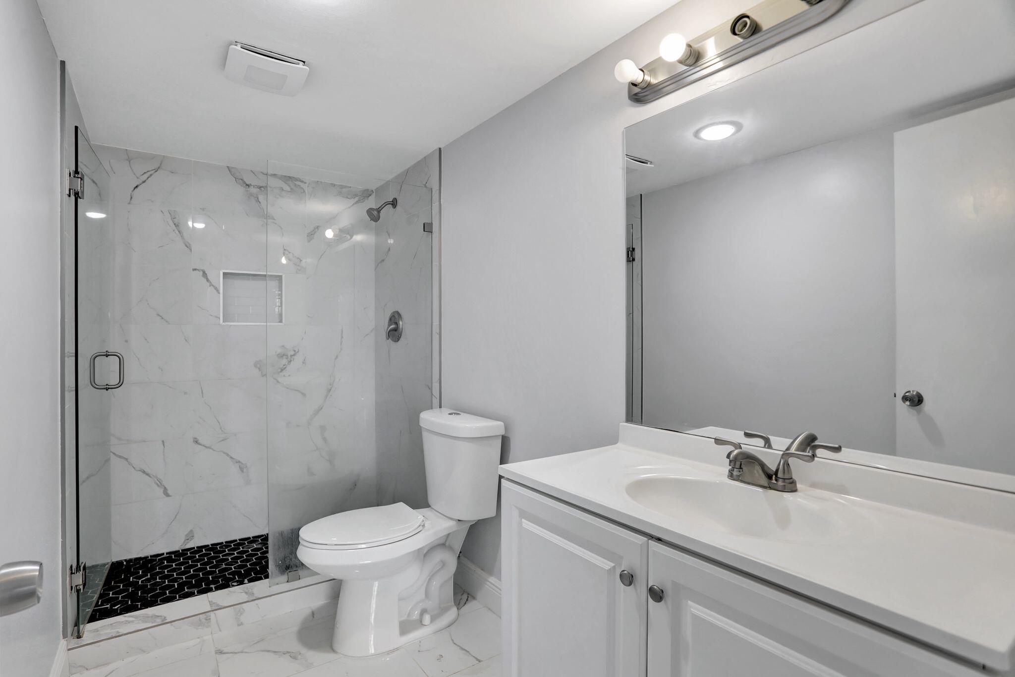 4156 Inverrary Drive, Unit 111 Lauderhill, FL 33319 - Photo 8 of 18 a bathroom with a sink toilet and shower