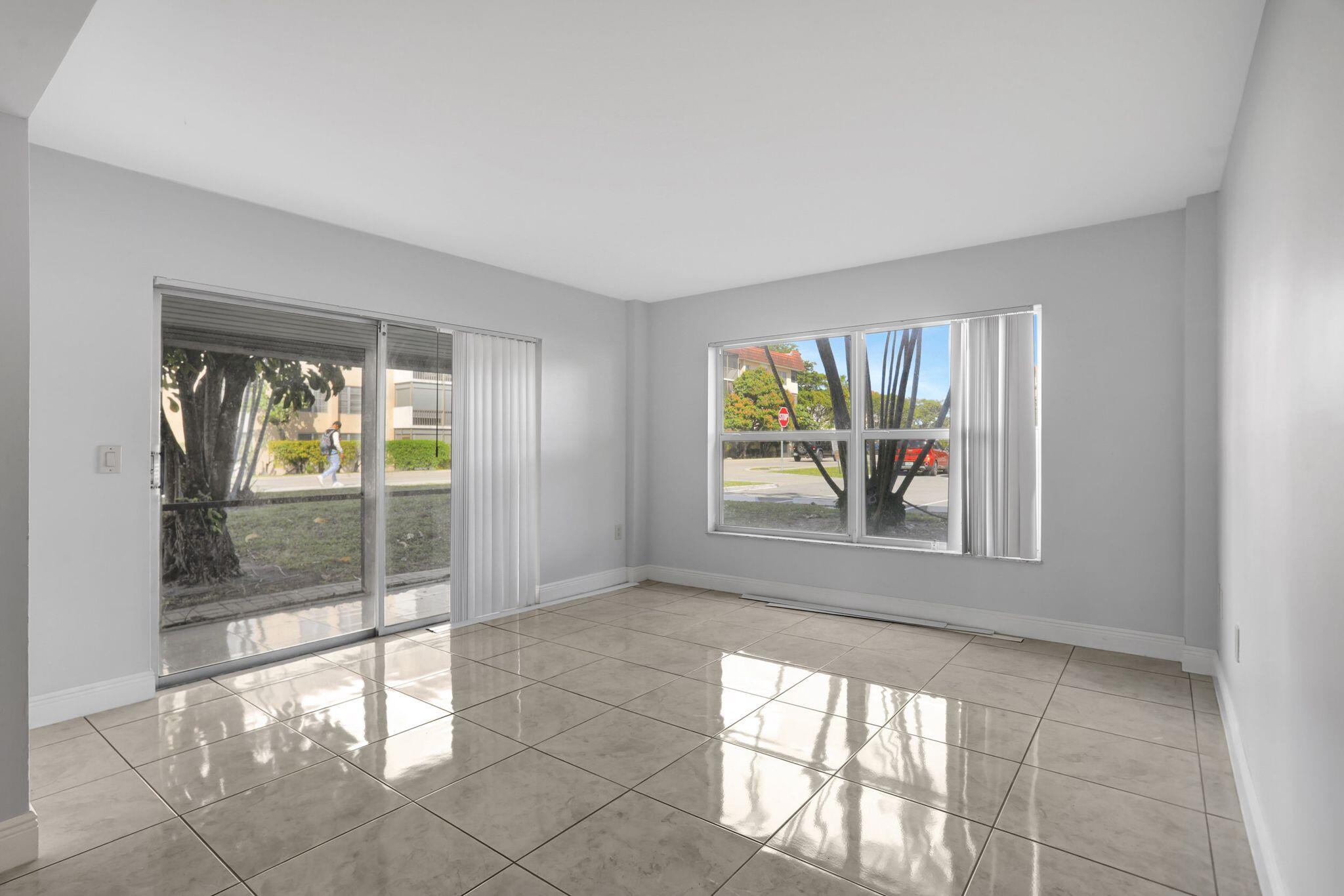 4156 Inverrary Drive, Unit 111 Lauderhill, FL 33319 - Photo 10 of 18 wooden floor in an empty room with a window
