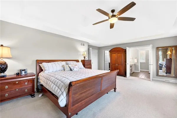 a bedroom with a bed and ceiling fan
