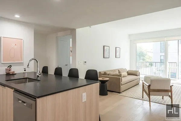 a living room with furniture and two large window