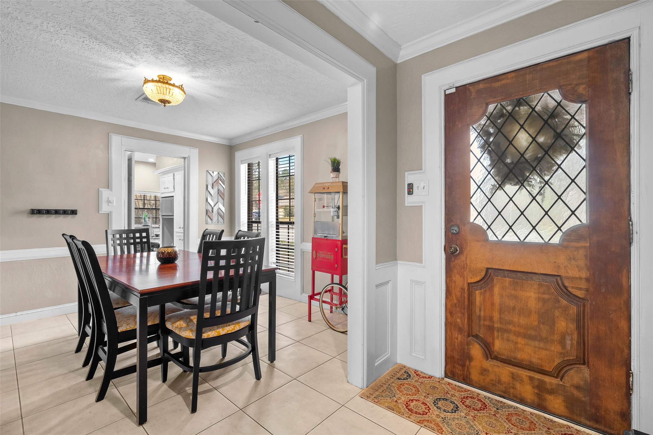 41 Windsor Drive Conroe, TX 77304 - Photo 12 of 39 The front entry connects seamlessly to the dining area, featuring crown molding and classic trim details. This layout creates a smooth transition between welcoming guests and hosting meals.