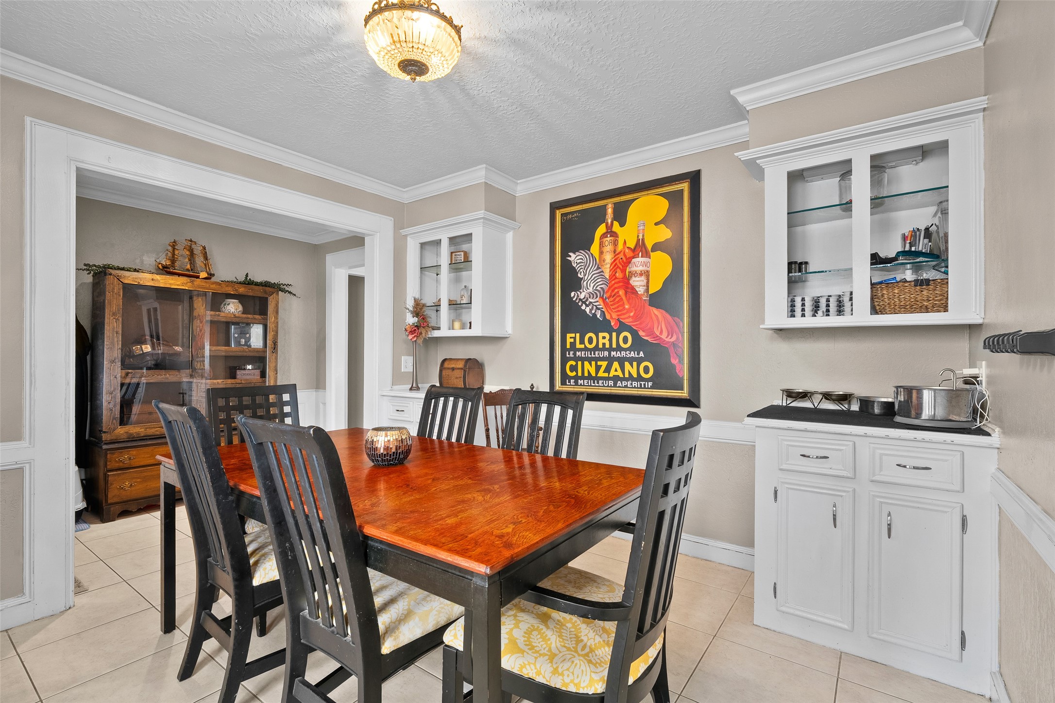 41 Windsor Drive Conroe, TX 77304 - Photo 13 of 39 The dining room offers a dedicated space for gatherings, highlighted by built-in cabinetry for storage or display. Neutral tones and tile flooring keep the room bright and versatile.
