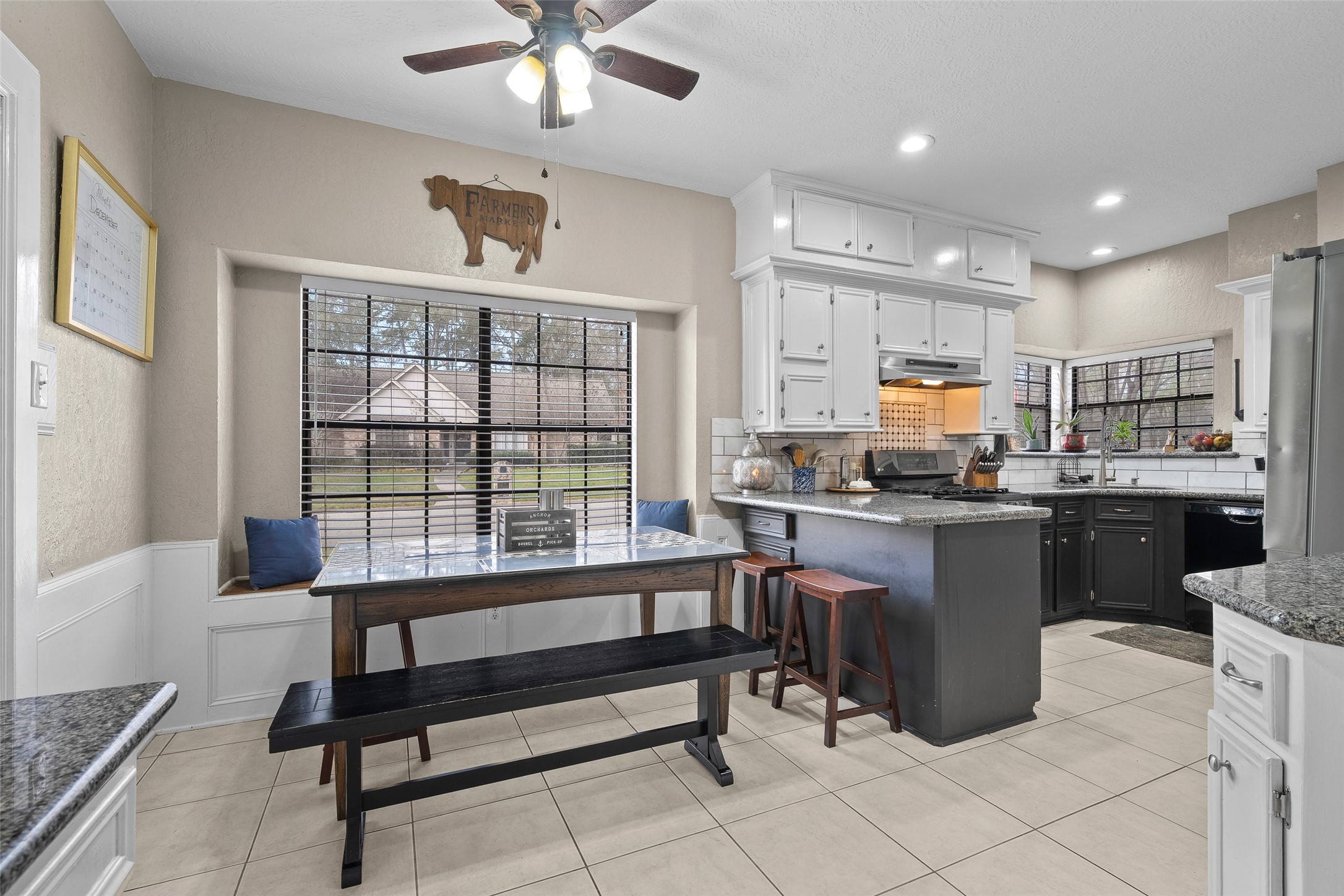 41 Windsor Drive Conroe, TX 77304 - Photo 15 of 39 The breakfast area features a window seat and natural light, offering a casual dining space adjacent to the kitchen.