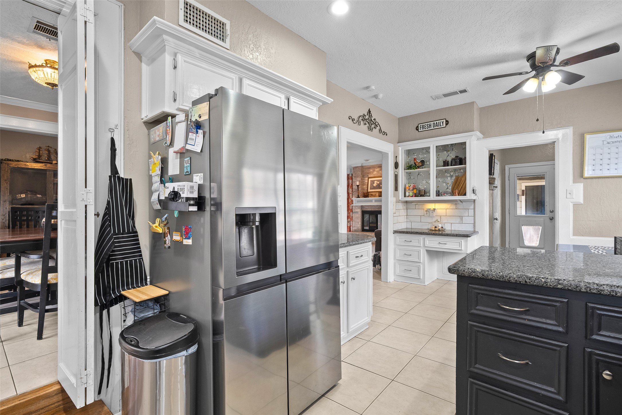 41 Windsor Drive Conroe, TX 77304 - Photo 17 of 39 Kitchen view showing stainless steel refrigerator with direct access to the adjacent dining area.