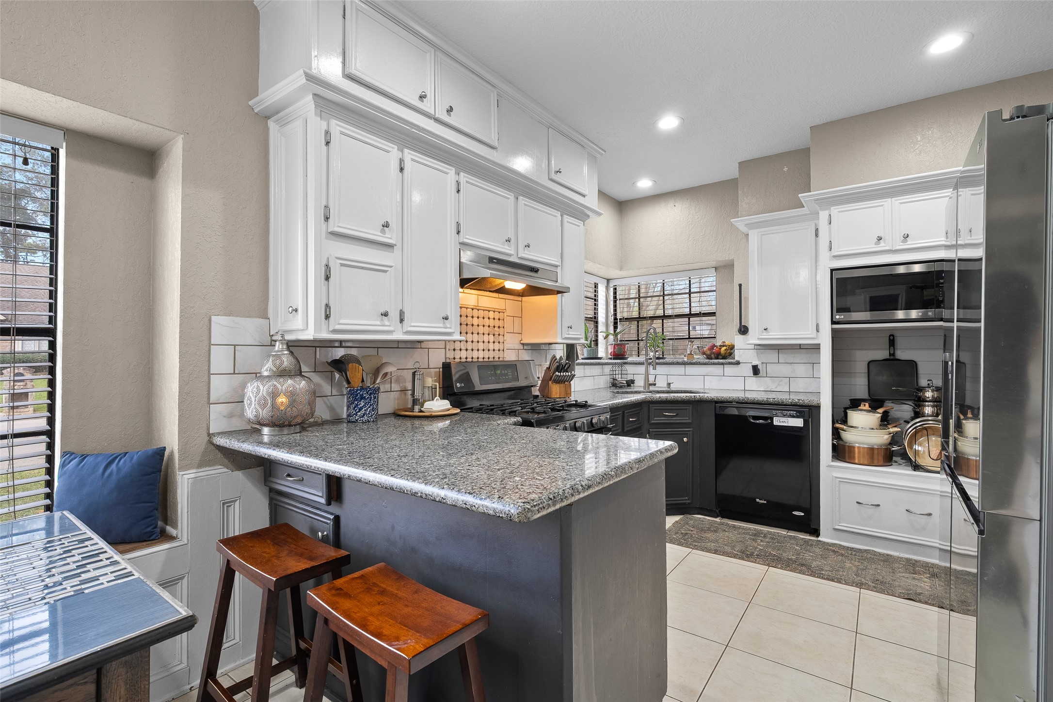 41 Windsor Drive Conroe, TX 77304 - Photo 18 of 39 This angle focuses on the kitchen workspace, including the island, cabinetry, and cooking area, designed for practical meal prep and storage.