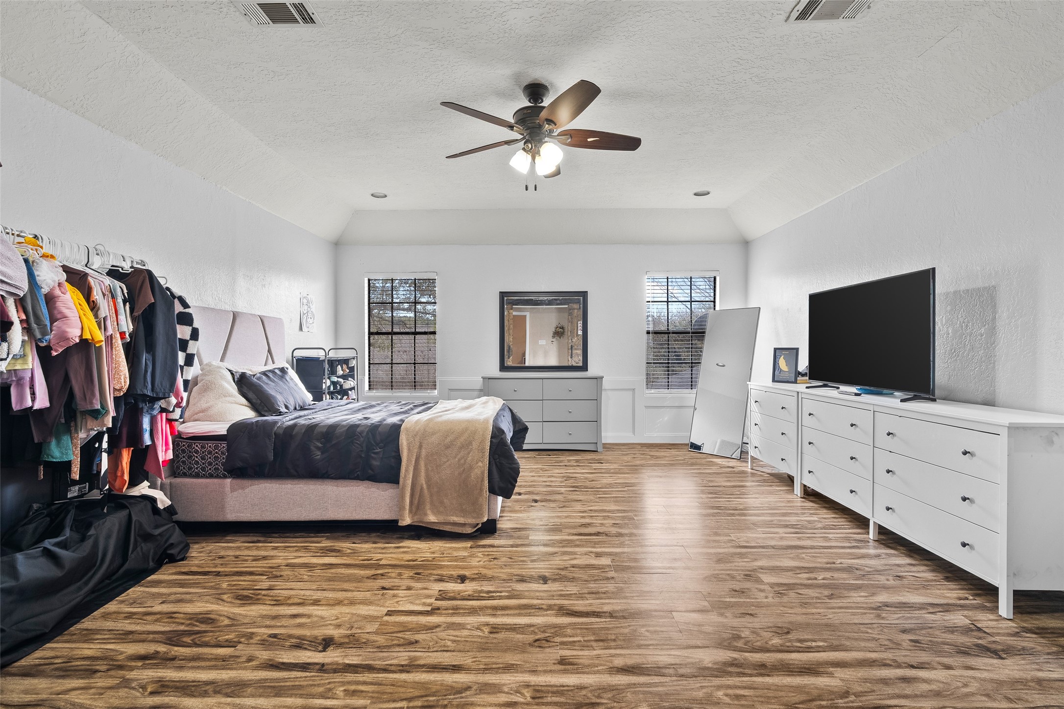 41 Windsor Drive Conroe, TX 77304 - Photo 30 of 39 Second angle highlights the generous size of the converted game room, featuring vaulted ceilings, wood-style flooring, ceiling fan, and abundant natural light. The open layout easily accommodates a bedroom setup, media area, or multi-purpose flex space.
