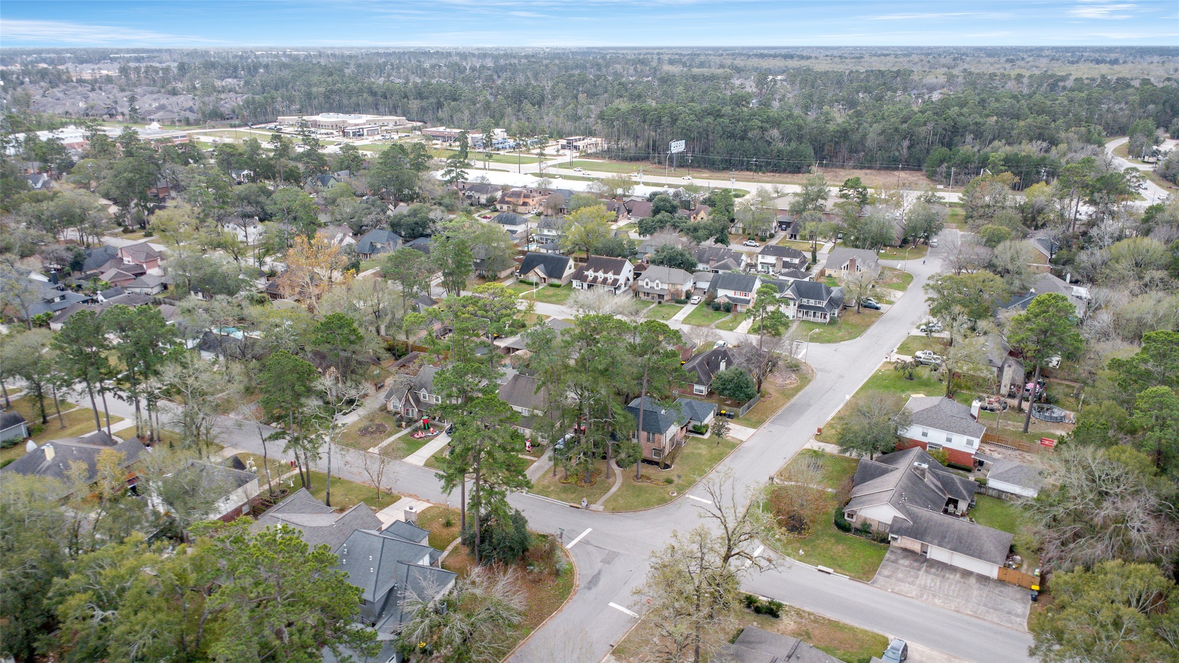 41 Windsor Drive Conroe, TX 77304 - Photo 38 of 39 Wide neighborhood perspective highlighting the Rivershire community, featuring mature trees, established homes, and quiet residential streets. Located in Conroe with convenient proximity to Grand Central Park shopping Center, The Woodlands, and accessible to major travel corridors including I-45, Hwy 242, and FM 1488, connecting residents to nearby shopping, dining, schools, and everyday amenities.