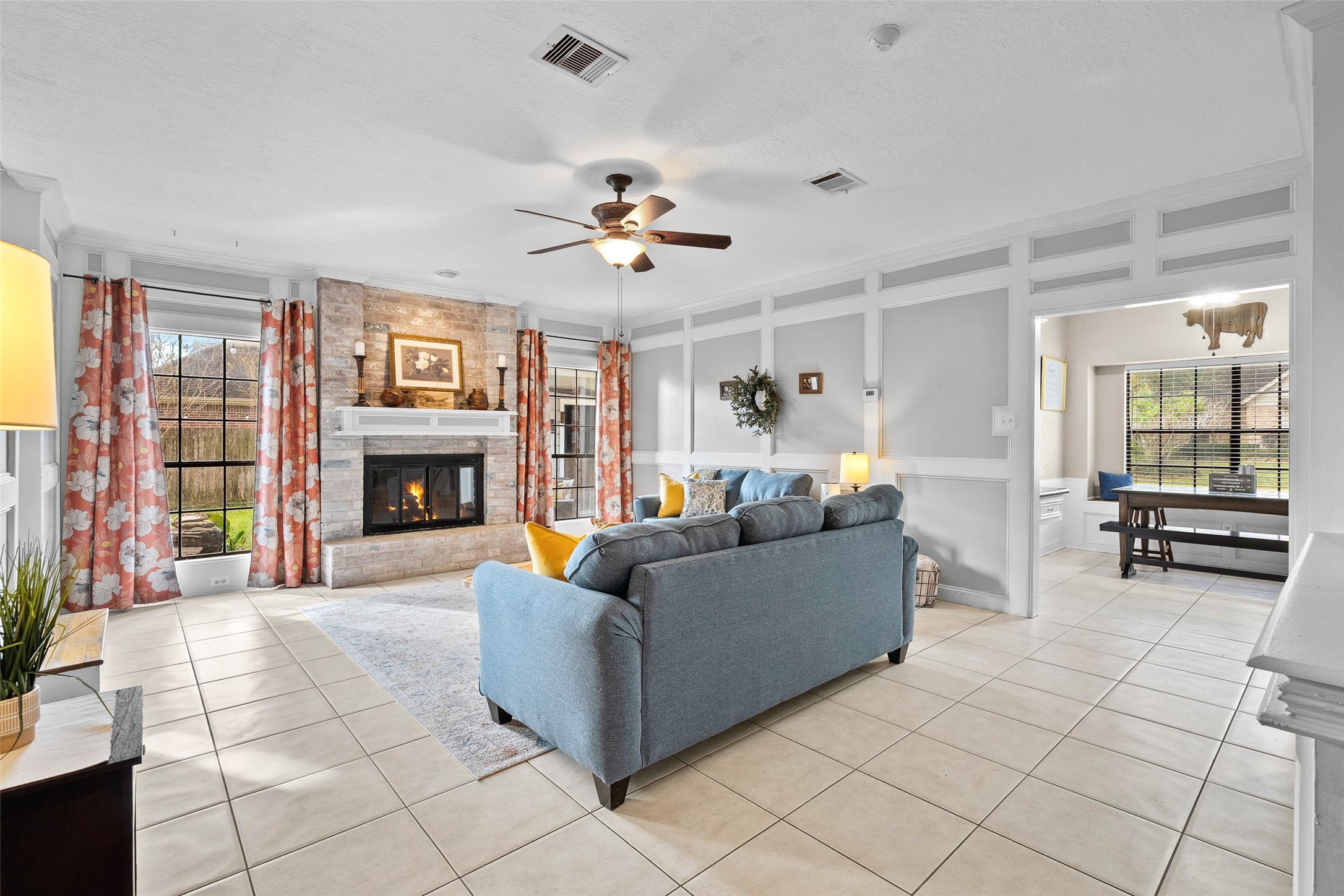 41 Windsor Drive Conroe, TX 77304 - Photo 10 of 39 This angle shows the living room opening toward the breakfast area and kitchen, highlighting the home’s easy flow and open sightlines. The layout keeps everyday living connected while still defining each space.