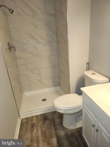 a white toilet sitting next to a bath tub
