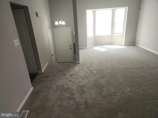 an empty room with windows and entrance