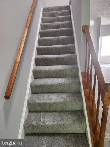 a view of staircase with white walls and stairs