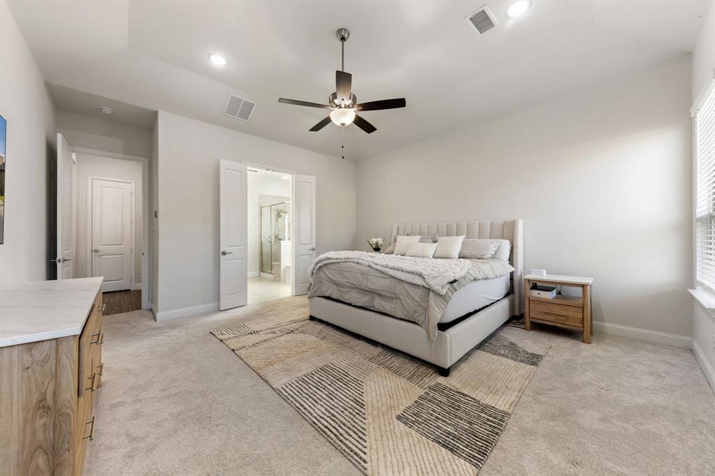 8808 Royal Star Road Rowlett, TX 75089 - Photo 22 of 40 a bedroom with a bed lamp and a dresser