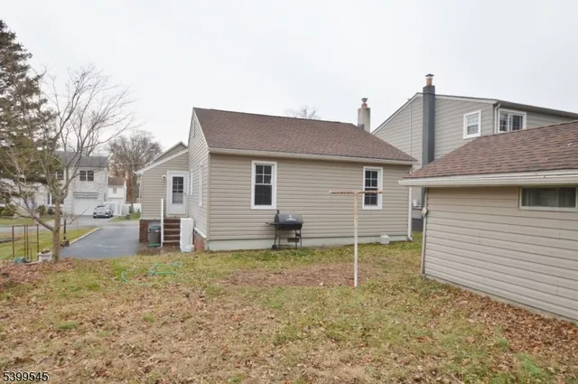 a house that has a small yard and large trees